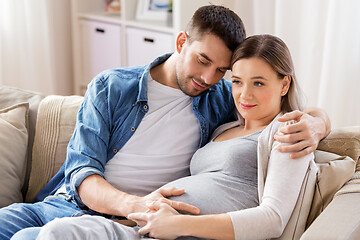 Image showing man hugging pregnant woman at home