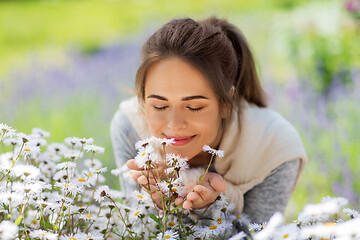 Image showing close up of woman smelling chamomile flowers