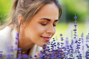 Image showing close up of woman smelling lavender flowers