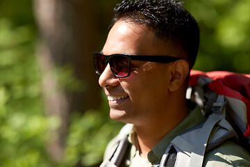 Image showing happy indian man with backpack hiking in forest