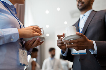 Image showing business people with conference badges and coffee