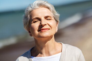 Image showing portrait of senior woman enjoying sun on beach