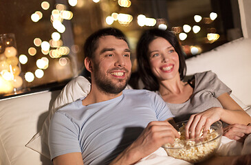 Image showing couple with popcorn watching tv at night at home