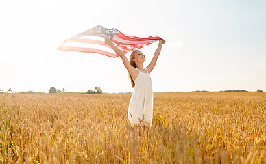 Image showing girl with american flag waving over cereal field