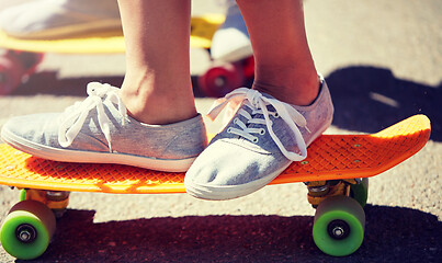 Image showing close up of feet riding skateboards on city street