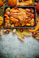 Image showing Roasted whole chicken or turkey with pumpkins, pepper and potatoes. With colorful mini pumpkins