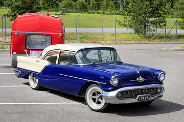 Image showing Classic Oldsmobile Super 88 Pulling Camper Trailer