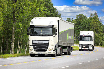 Image showing Two White Freight Trucks on Highway