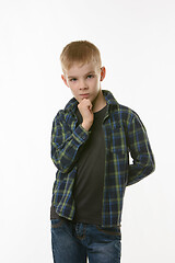 Image showing Portrait of a pensive boy in a plaid shirt on a white background
