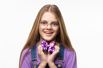 Image showing Cheerful girl in glasses holds a beautiful blue bow in her hands