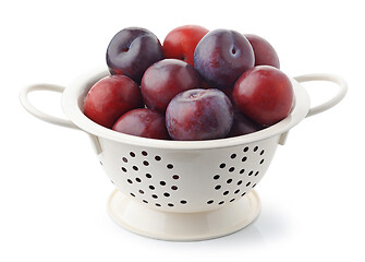 Image showing fresh ripe plums in white colander