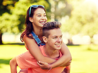 Image showing happy teenage couple having fun at summer park