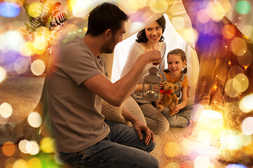 Image showing happy family playing in kids tent at night at home