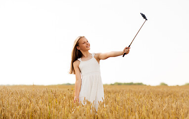 Image showing happy young girl taking selfie by smartphone