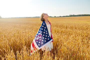 Image showing happy girl in american flag on cereal field