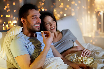 Image showing couple with popcorn watching tv at night at home