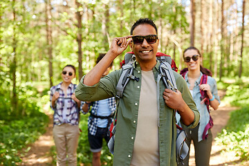 Image showing friends with backpacks on hike in forest