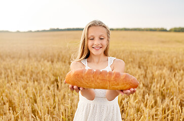 Image showing girl with loaf of white bread on cereal field