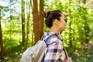 Image showing happy asian woman with backpack hiking in forest