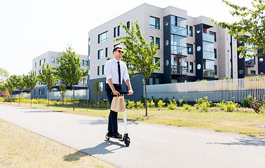 Image showing businessman with takeaway lunch riding scooter