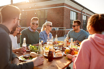 Image showing friends having dinner or bbq party on rooftop