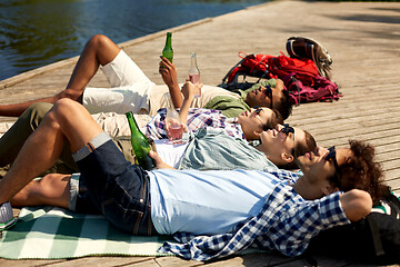 Image showing friends drinking beer and cider on lake pier