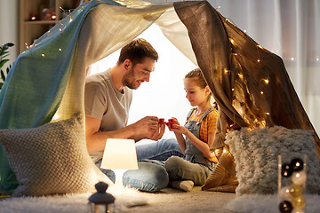 Image showing family playing tea party in kids tent at home