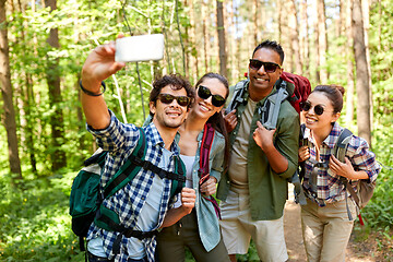 Image showing friends with backpacks hiking and taking selfie