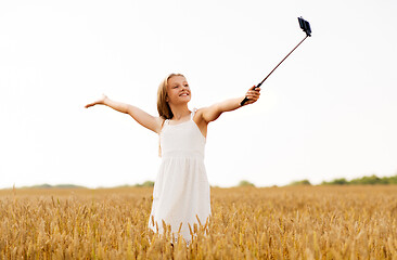 Image showing happy young girl taking selfie by smartphone