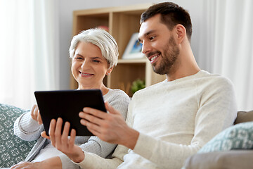 Image showing old mother and adult son with tablet pc at home