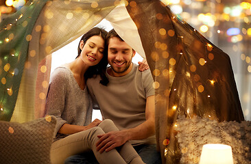 Image showing happy couple in kids tent at home