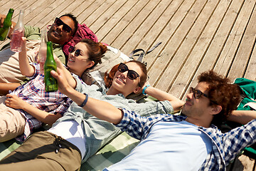 Image showing friends drinking beer and cider on wooden terrace