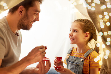 Image showing family playing tea party in kids tent at home