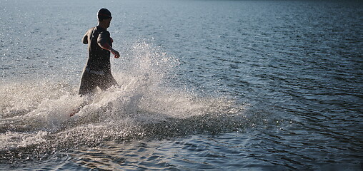 Image showing triathlon athlete starting swimming training on lake