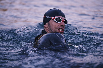 Image showing triathlete swimmer having a break during hard training