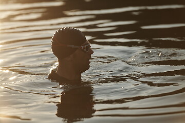 Image showing triathlete swimmer having a break during hard training