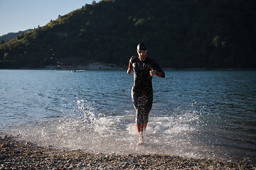 Image showing triathlon athlete starting swimming training on lake