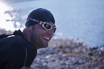 Image showing triathlon athlete starting swimming training on lake