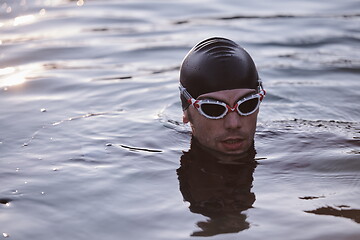 Image showing triathlete swimmer having a break during hard training