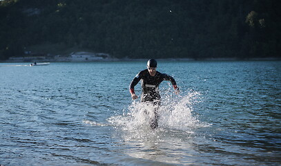 Image showing triathlon athlete starting swimming training on lake