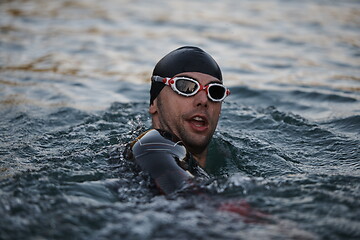 Image showing triathlete swimmer having a break during hard training