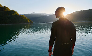 Image showing triathlon athlete starting swimming training on lake