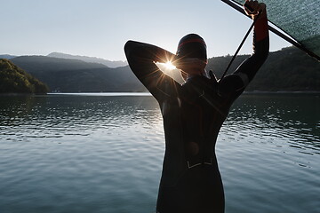 Image showing triathlon athlete starting swimming training on lake