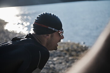 Image showing triathlon athlete starting swimming training on lake