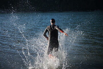 Image showing triathlon athlete starting swimming training on lake