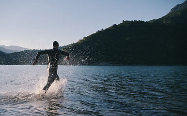 Image showing triathlon athlete starting swimming training on lake