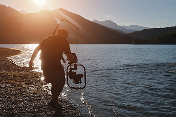 Image showing videographer taking action shot of triathlon swimming athlete