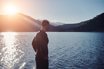 Image showing triathlon athlete starting swimming training on lake