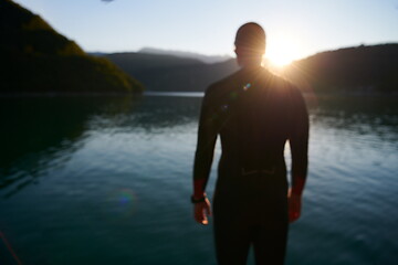 Image showing triathlon athlete starting swimming training on lake