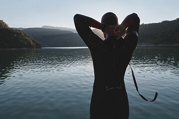 Image showing triathlon athlete starting swimming training on lake